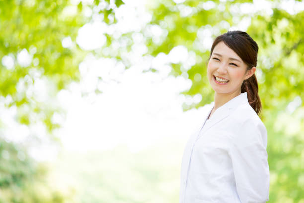 young asian doctor relaxing in park
