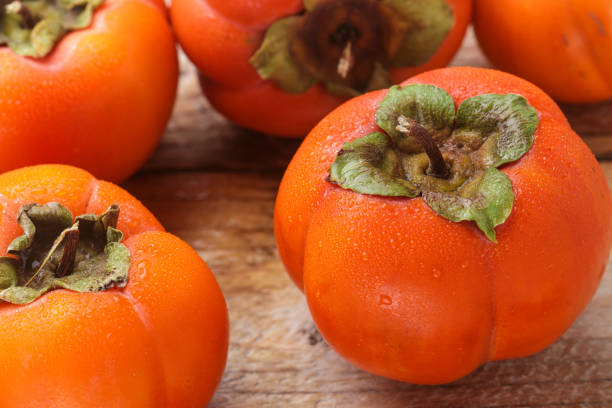 istock Fresh ripe persimmon with water drops. Selective focus 865541808