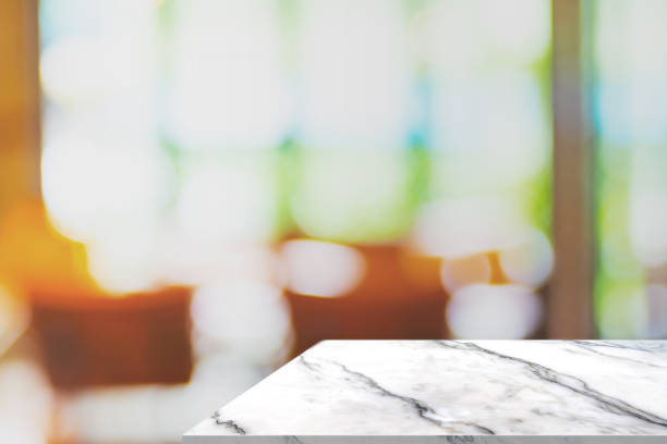 istock Empty white marble table at blurred coffee shop with window background,Mock up for display or montage of design for online shopping promotion. 865543638