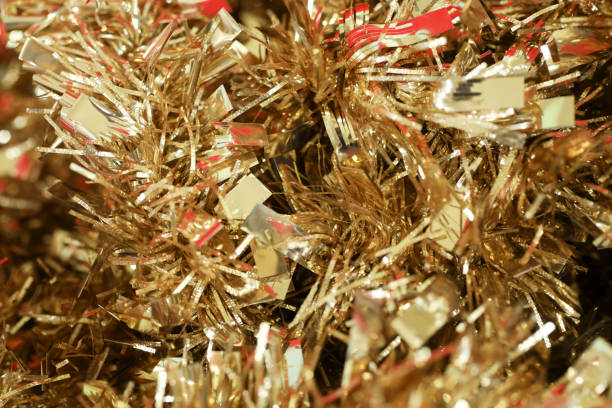 istock Gold Christmas tinsel, holiday background. 865552114