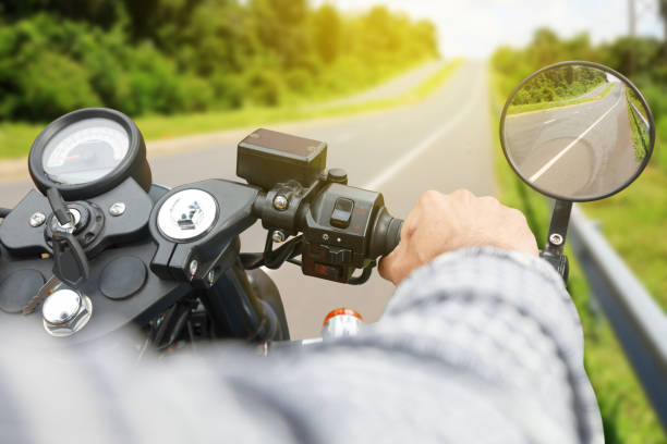 istock Driver riding motorcycle on an asphalt road. 865552698
