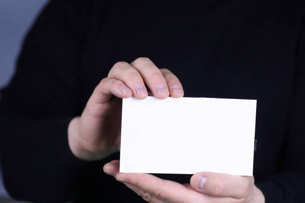 istock small white piece of paper in his hand man 865553228