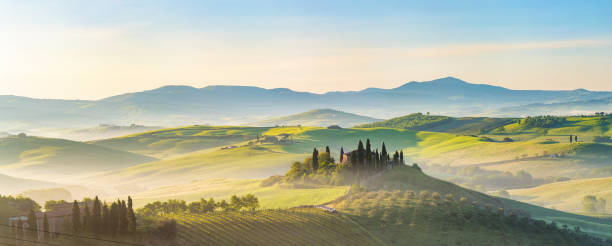 Tuscany at spring morning Beautiful foggy landscape in Tuscany, Italy agritourism stock pictures, royalty-free photos & images