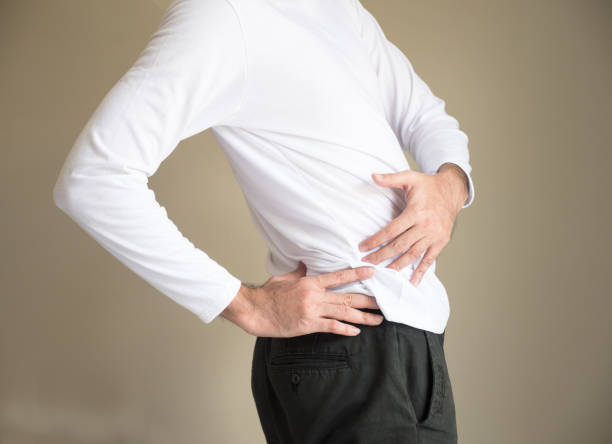 istock Selected focus on a man's hand touch his waist and back as a backache or painful 865555880