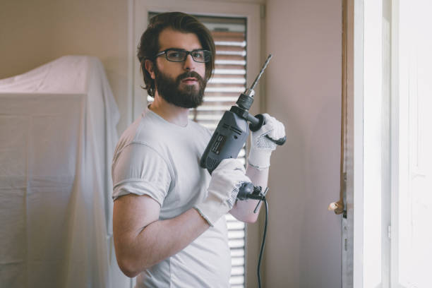 istock Handsome bearded man whit an electric drill 865566500