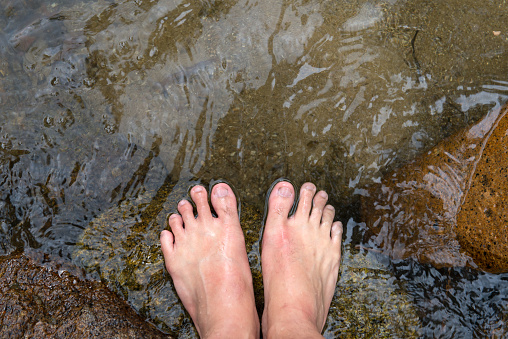 Bare foot soak in clear water on creek