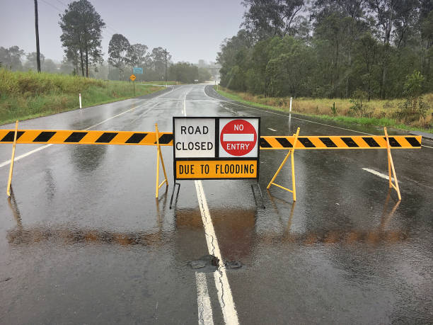 Flooded Road Flooding on road, Australia. Location: Gympie, Sunshine Coast on on Can Bay Road road closed sign horizontal road nobody stock pictures, royalty-free photos & images