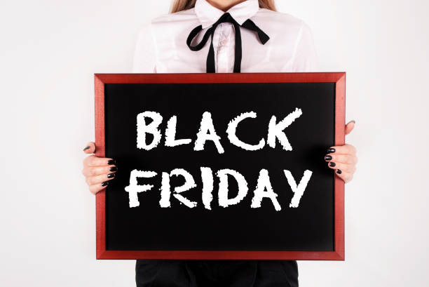 istock Black board in female hands. Black Friday words on table 865573720