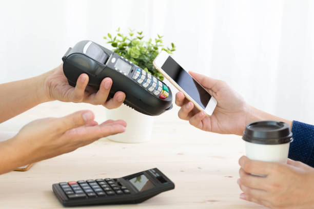 istock use paying bill in cafe  NFC technology through smartphone 865573920
