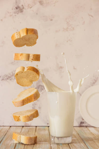 istock Bread and milk. Flying baguette and milk splash in a glass 865576968