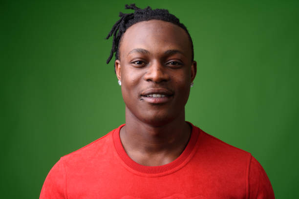 Young handsome African man from Kenya against green background Studio shot of young handsome African man from Kenya against green background kenyan man stock pictures, royalty-free photos & images