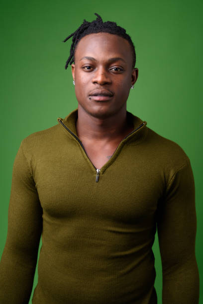 istock Young handsome African man from Kenya against green background 865582630