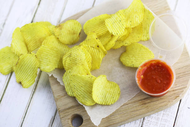 istock Potato chips on a wooden tray 865584834