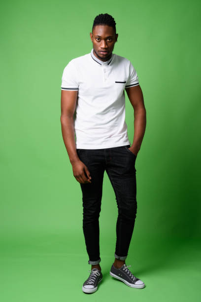 istock Young handsome African man from Kenya against green background 865585058