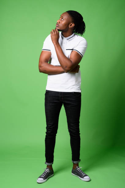 istock Young handsome African man from Kenya against green background 865585090