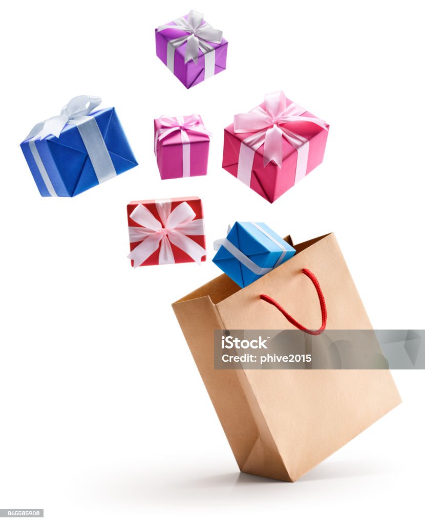 Gift boxes pop out from shopping bag Gift boxes pop out from paper bag isolated on white background Shopping Bag Stock Photo