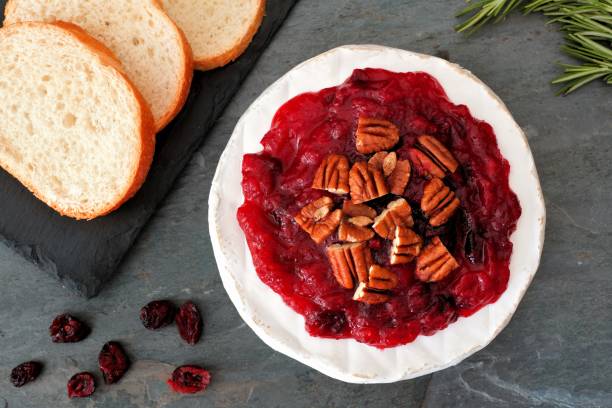 istock Brie topped with cranberries and pecans, overhead scene 865585974