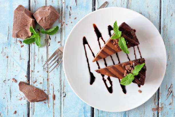 istock Chocolate cheesecake above view over rustic blue wood 865586396