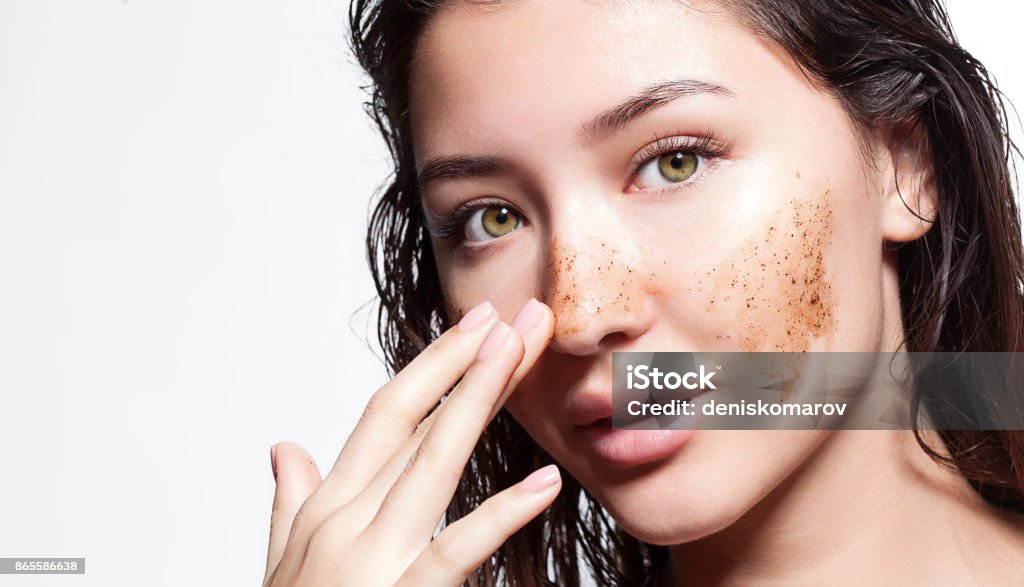 Beautiful woman cleans the skin scrub on a white background isolated Exfoliation Stock Photo