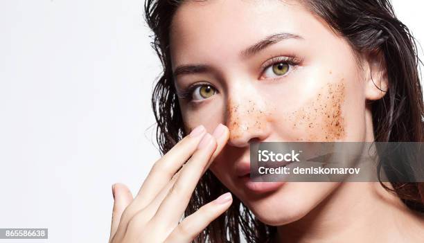 Beautiful Woman Cleans The Skin Scrub On A White Background Isolated Stock Photo - Download Image Now