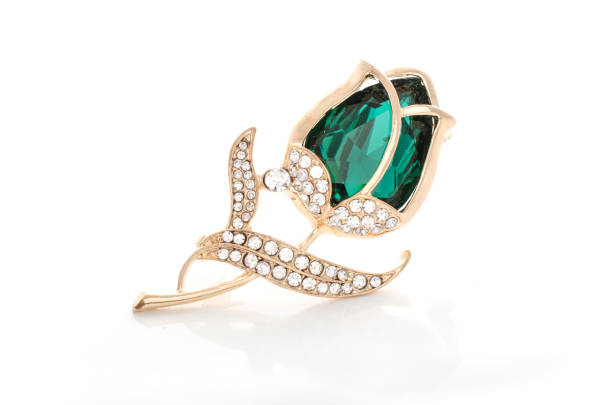 istock gold brooch rose bud with emerald and diamonds isolated on white 865590006