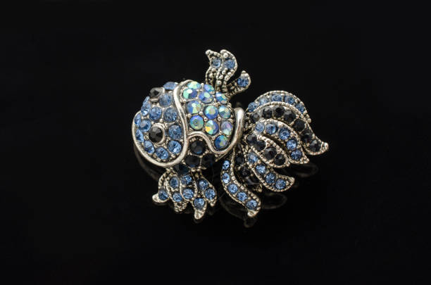 istock brooch fish with diamonds isolated on black 865590160
