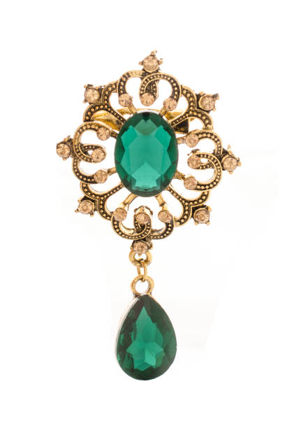 istock golden vintage brooch with emeralds isolated on white 865592304