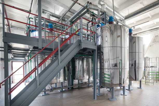 Steel chrome cisterns. Yeast mixture preparation system Steel chrome cisterns. Yeast mixture preparation system. Plenty of pipelines and pumps. yeast cells stock pictures, royalty-free photos & images