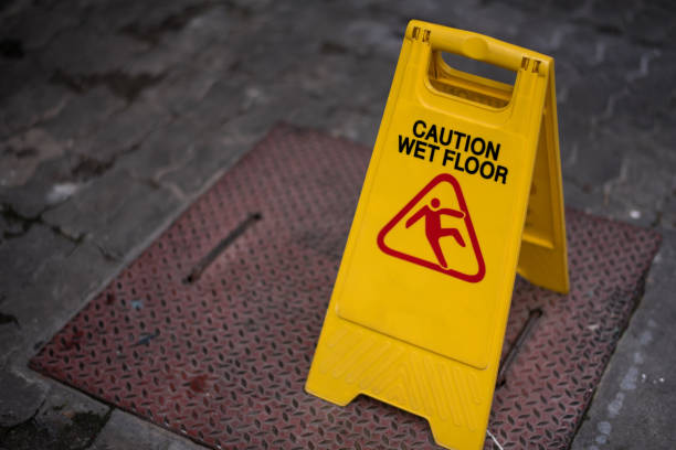 istock Close up yellow caution wet floor sign with copy space for text. 865604314