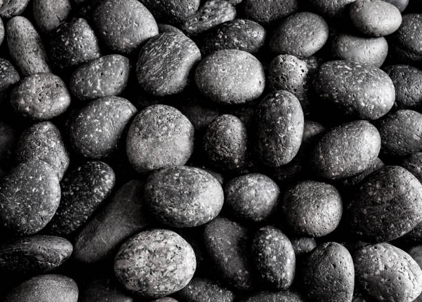 istock Texture of dried round gray river stone background 865604778