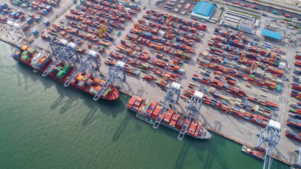 istock container,container ship in import export and business logistic,By crane,Trade Port , Shipping,cargo to harbor.Aerial view,Water transport,International,Shell Marine,transportation,logistic,trade,port 865604872