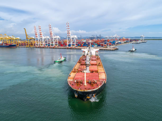 istock container,container ship in import export and business logistic,By crane,Trade Port , Shipping,cargo to harbor.Aerial view,Water transport,International,Shell Marine,transportation,logistic,trade,port 865604906