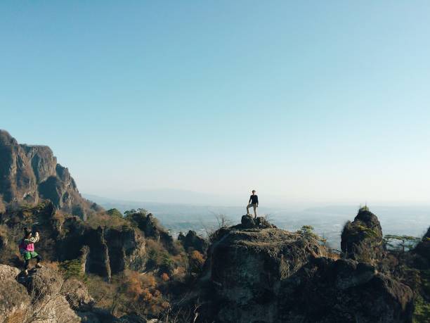 istock Front View Full Length Of Man Standing On Mountain Against Sky 865607262