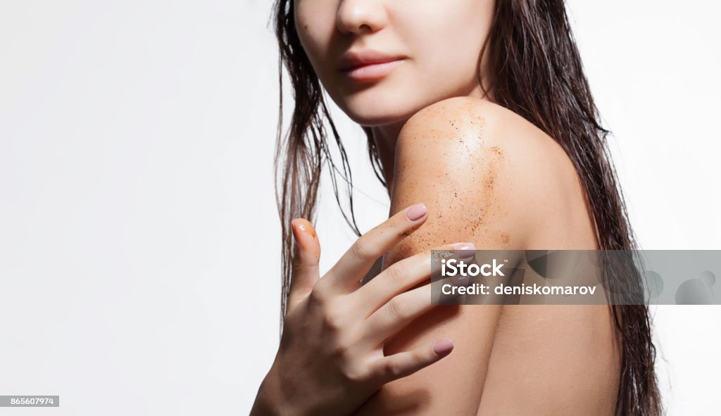 Close-up of a woman's shoulder with scrub of coffee Exfoliation Stock Photo