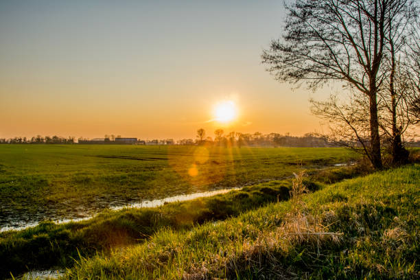 istock sunset in Europe Germany with a green field 865608444
