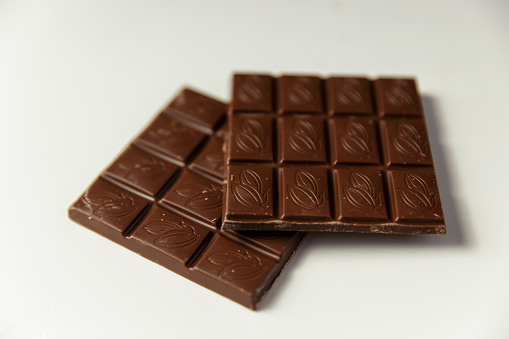 Chocolate pieces on a white background. Horizontal composition. Top view