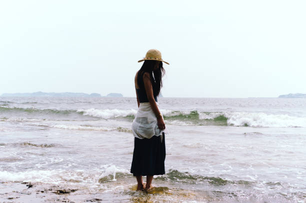 istock Woman Standing on Muddy Beach 865611590