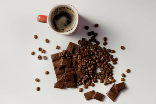 istock cup of hot coffee, beans coffee and chocolate on white table 865611610