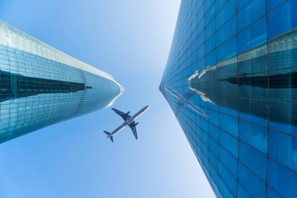 istock China,Nanchang,2016/12/31,Skyscrapers from a low angle view with a plane flying over 865611970