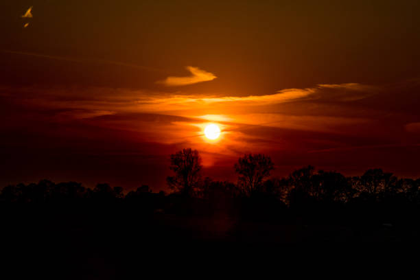 istock sunset in Europe Germany with a green field 865611998