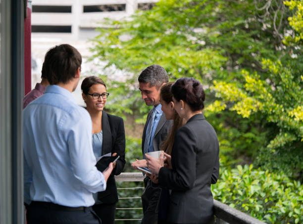 istock Confident business people discussing at balcony 865612632