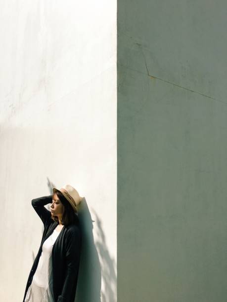 istock Side view of woman standing by white wall 865615106