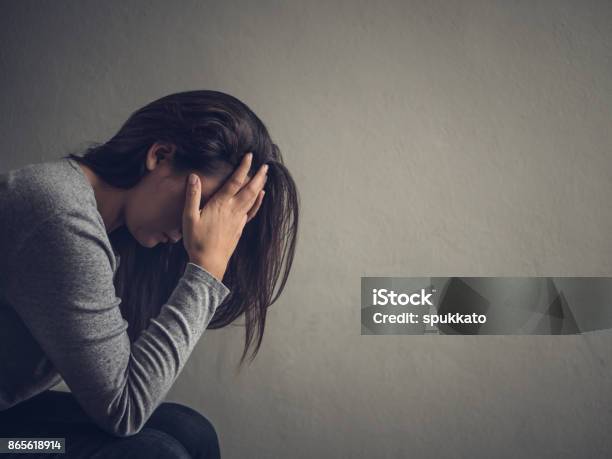 Depressed Woman Sitting On A Chair In Dark Room At Home Lonly Sad Emotion Concept Stock Photo - Download Image Now