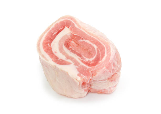 Coiled piece of the chilled streaky pork belly on a white background