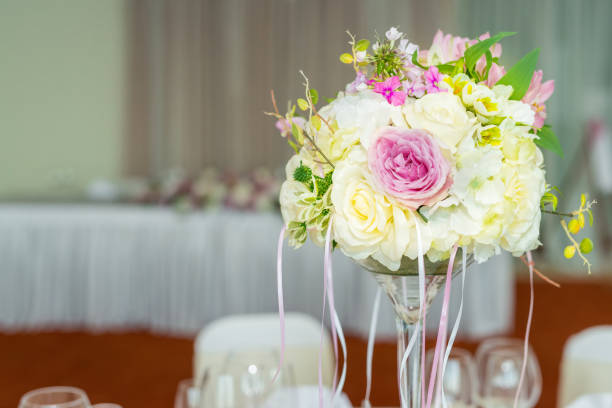 istock Beautiful wedding floral decoration on a table in a restaurant. 865620400