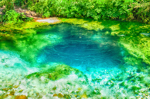 Beautiful turquoise spring Blue Eye (Syri i Kalter) near a town of Muzine, Albania. The spring is very powerful,  cold and deep and is a source of a river Bistrice