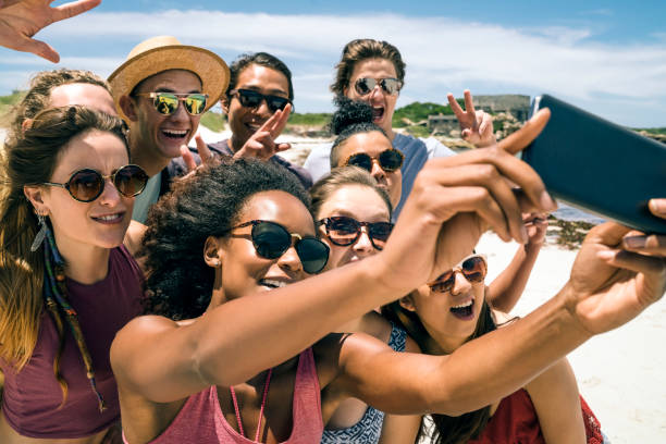 istock Friends taking selfie with smart phone at beach 865624980