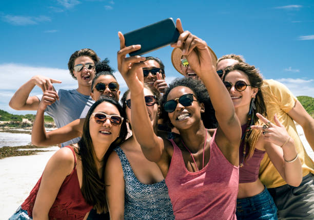istock Friends taking selfie with smart phone at beach 865625168