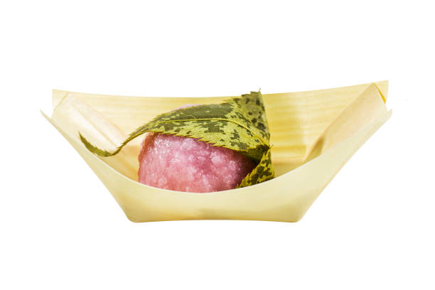 Pink Sticky rice cover with leaf Pink Sticky rice cover with leaf on white background mochi cherry blossom cake stock pictures, royalty-free photos & images