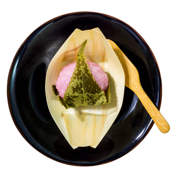 Mochi dessert sticky rice with sakura color Mochi dessert sticky rice with sakura color on black plate and white background mochi cherry blossom cake stock pictures, royalty-free photos & images